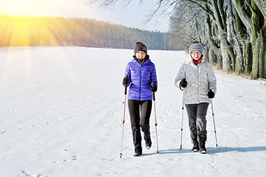 Fitting in fitness Image of two female friends walking outside in the winter.