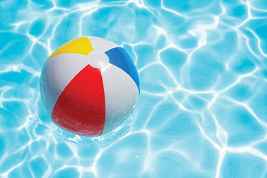 Image of beach ball in swimming pool.