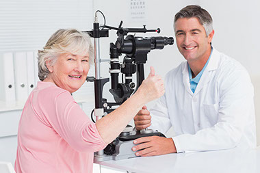 Diabetes related vision loss increasing. Image of older women with thumbs up at an eye doctor appointment.