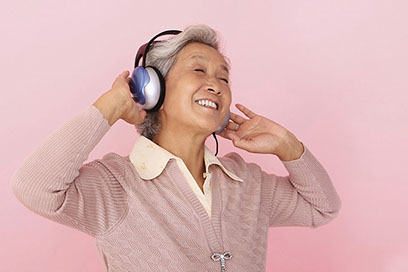 Image of older women with headphones.