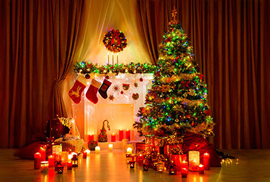 Image of Christmas tress in front of fire place.