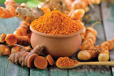 Small bowl filled with turmeric spice.
