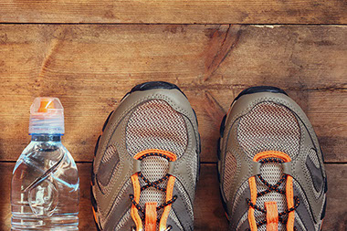 Image of athletic shoes and a bottle of water.