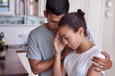 Image of a husband supporting his wife.