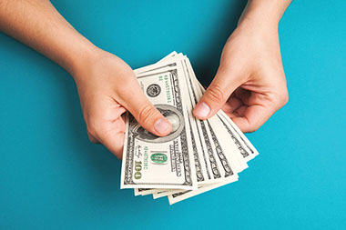 Managing financial stress Image of hands holding money.