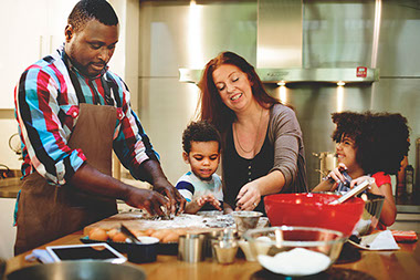 Family cooking together in kitchen.