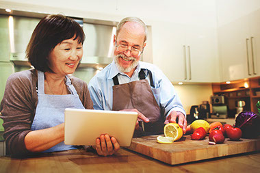 Image of couple cooking in kitchen.