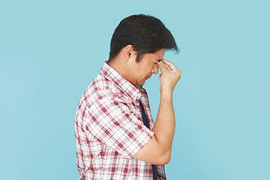 Image of man with a migraine.