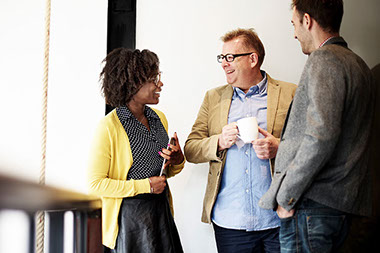 Employees talking over a coffee break.