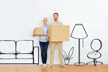 Image of couple holding moving boxes.