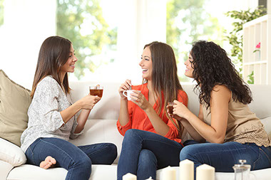 Image of 3 friends talking over tea and coffee.