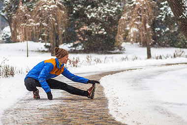 Image of person streching outside in winter. Image of person streching outside in winter.