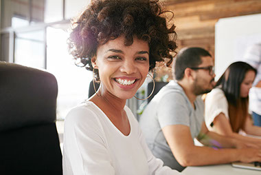 Image of smiling women at desk. Image of smiling women at desk.