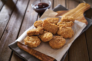 Chicken nuggets on a cutting board. Chicken nuggets on a cutting board.