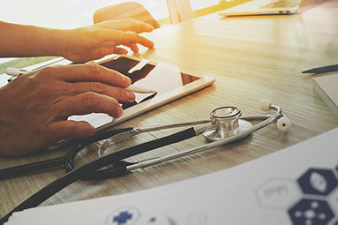 Close up of hand using a tablet.