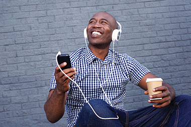 Image of man listening to music with headphones.