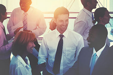 Image of co-workers talking and smiling.