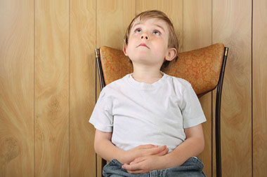 Image of young boy in a time out.