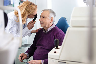 Eye doctor examining patients eye.