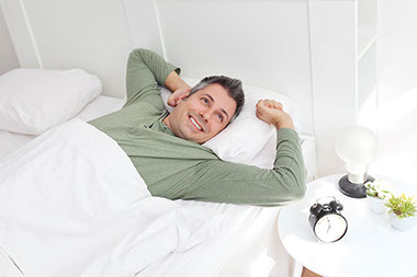 Image of man waking up happy.