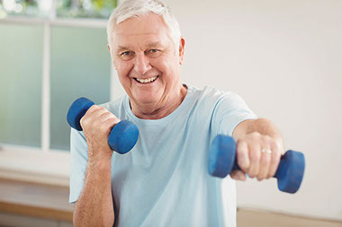 Older man using weights.