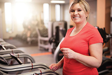Image of women using treadmill at a gym. Image of women using treadmill at a gym.