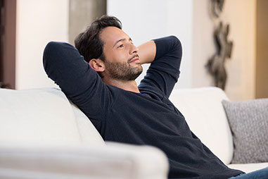 Image of man sitting on couch.