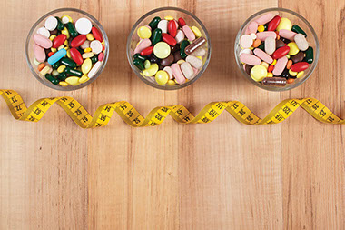 Pills in glasses with tape measure. Pills in glasses with tape measure.