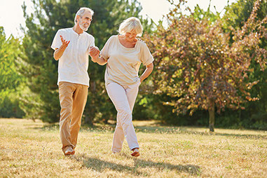 Exercise to keep pounds away Image of an older couple walking outside.