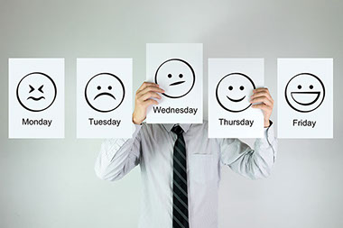 Image of the days of the week on paper with emotion faces.