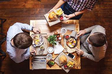Two people eating at a restaurant.