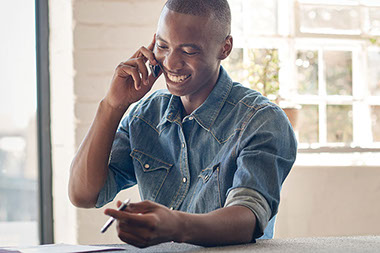 Smiling man talking on phone.