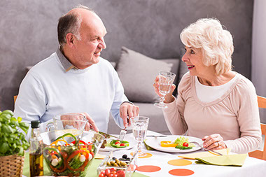 Elderly couple eating dinner. Elderly couple eating dinner.
