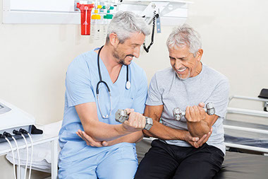 Doctor helping elderly man with fitness.