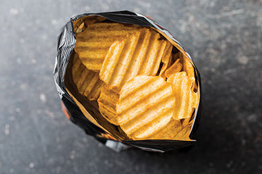 Open bag of potato chips. Open bag of potato chips.