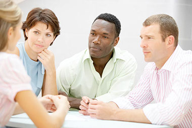 Image of 4 people sitting and talking.