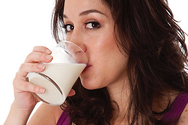 Protect your bones. Image of women drinking a glass of milk.