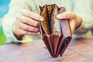 Person holding open empty wallet.