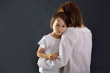 Image of mom holding child with a bump on the head.