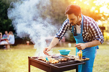 Man grilling food outside. Man grilling food outside.