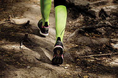 Close up of running legs wearing compression socks.