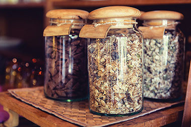 Choosing healthy oats. Image of oats in jars.