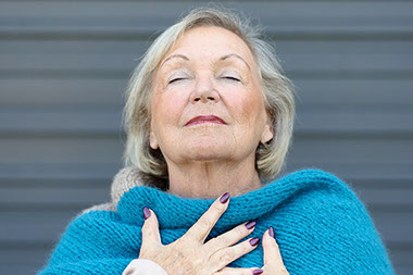 Senior women deep breathing.