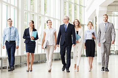 Business team with folders walking along office building and talking. Business team with folders walking along office building and talking.