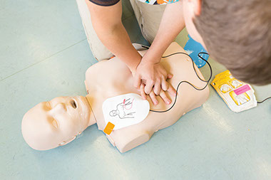 Person training to use an AED.