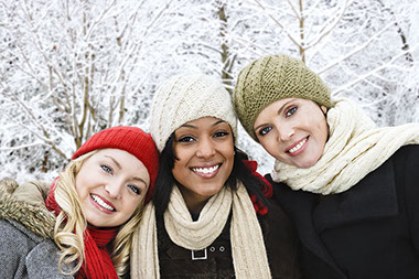 Image of three friends outside during winter.