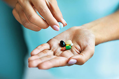 Close up image of hand with supplements. Close up image of hand with supplements.