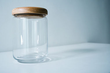 An empty clear glass jar. An empty clear glass jar.