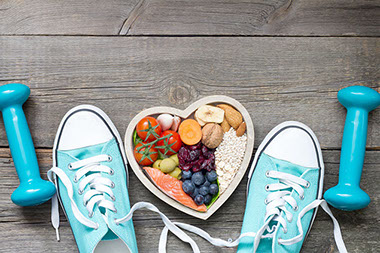 Healthy lifestyle concept with food in heart and sports fitness accessories. Healthy lifestyle concept with food in heart and sports fitness accessories.