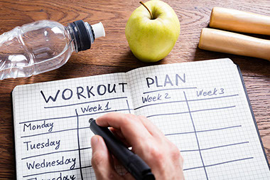 Workout plan in notebook.